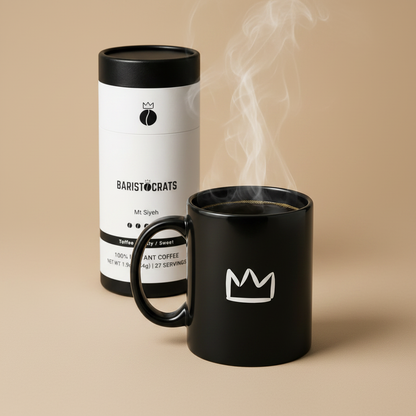 Steaming black crown mug with handle filled with coffee, Baristocrats Mt Siyeh canister in background